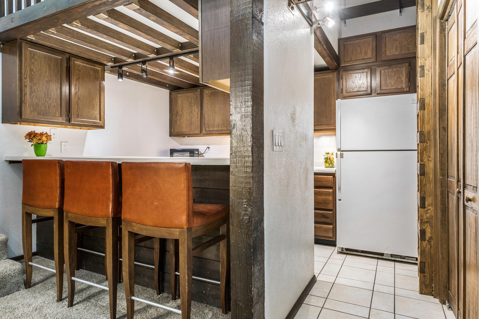 225 Gopher Road, Unit H54 Avon, CO 81620 - Photo 8 of 33 a kitchen with a refrigerator and cabinets