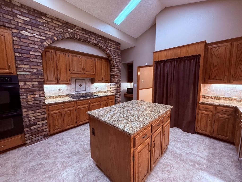 12098 Squirrel Road Pittsburg, TX 75686 - Photo 11 of 37 a kitchen with stainless steel appliances granite countertop a stove a sink dishwasher and a refrigerator