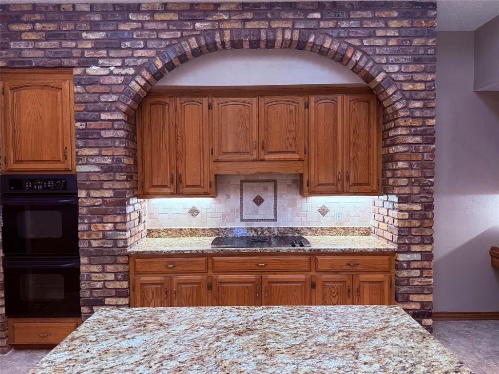 12098 Squirrel Road Pittsburg, TX 75686 - Photo 12 of 37 a kitchen with granite countertop a sink cabinets and stainless steel appliances