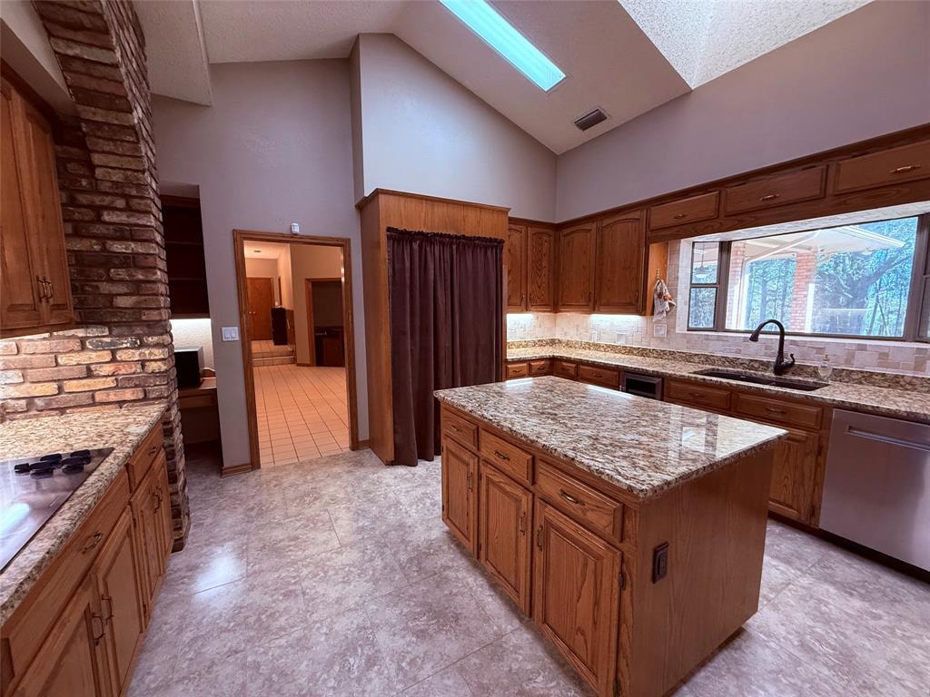 12098 Squirrel Road Pittsburg, TX 75686 - Photo 13 of 37 a kitchen with stainless steel appliances granite countertop a stove a sink and a refrigerator