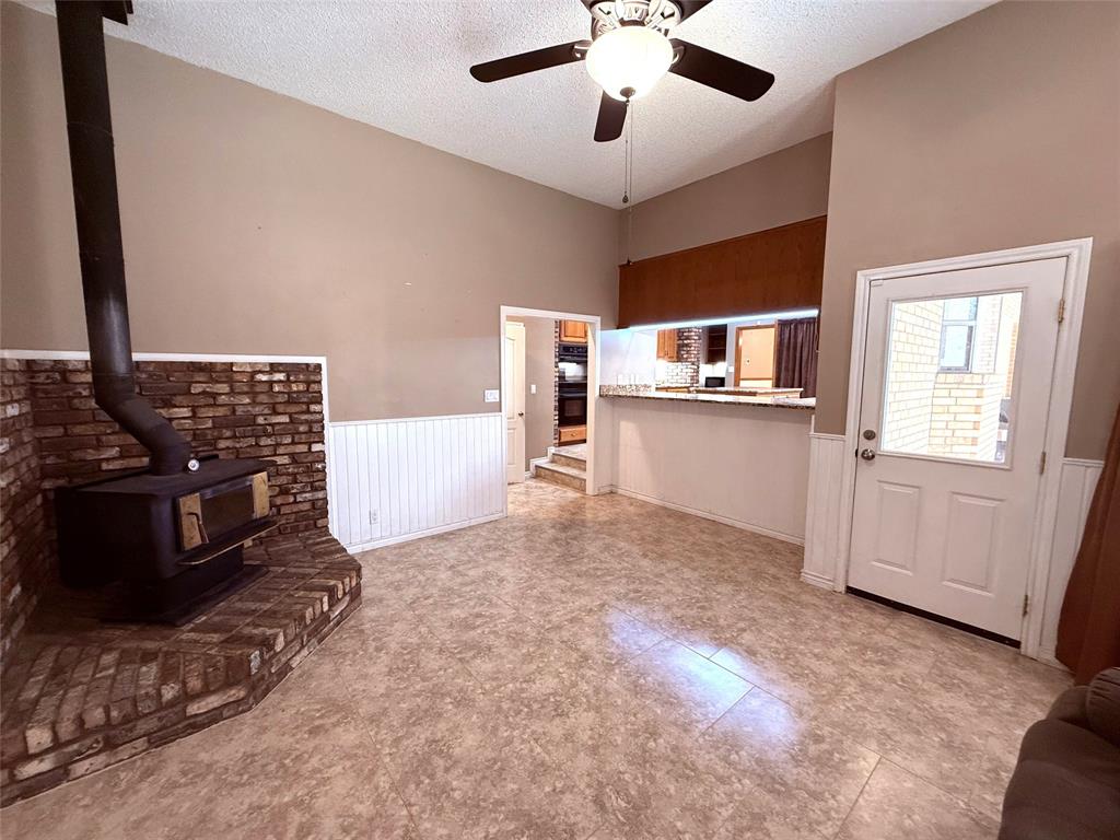 12098 Squirrel Road Pittsburg, TX 75686 - Photo 15 of 37 a living room with stainless steel appliances kitchen island granite countertop a stove and a refrigerator