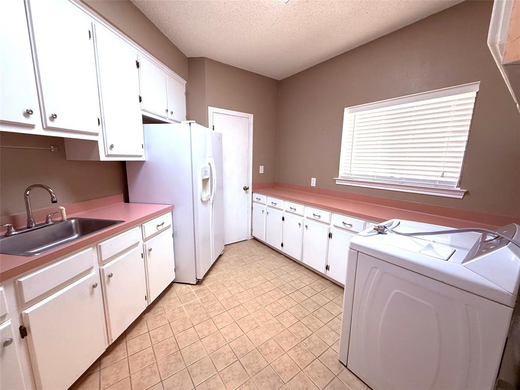 12098 Squirrel Road Pittsburg, TX 75686 - Photo 17 of 37 a kitchen with stainless steel appliances a sink and a refrigerator