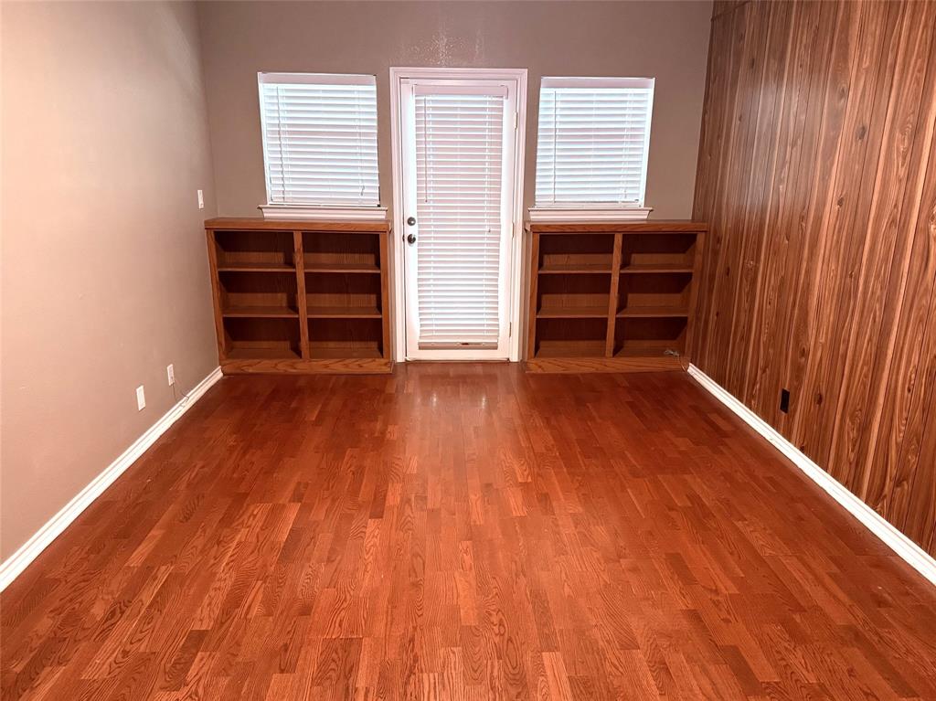 12098 Squirrel Road Pittsburg, TX 75686 - Photo 22 of 37 an empty room with wooden floor and windows