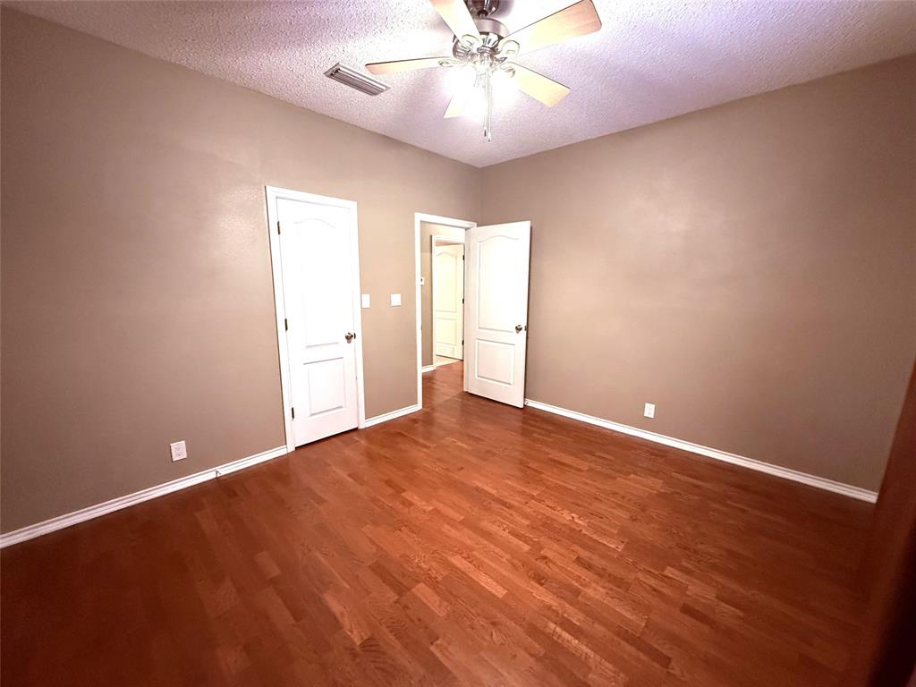 12098 Squirrel Road Pittsburg, TX 75686 - Photo 26 of 37 an empty room with wooden floor and windows