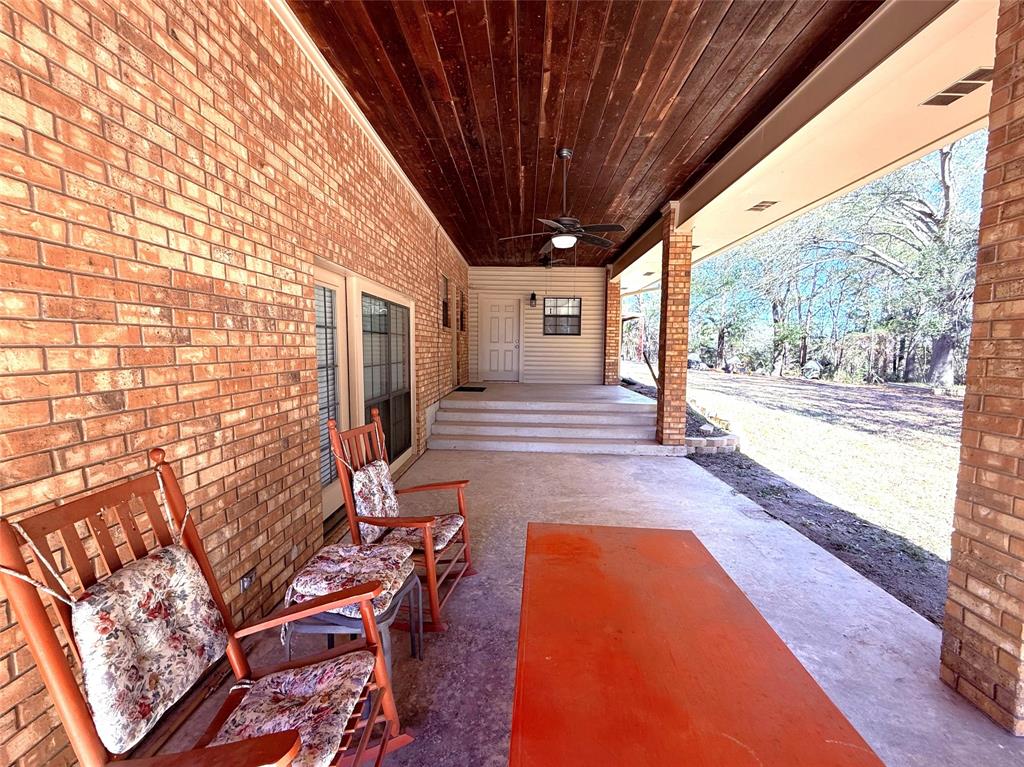 12098 Squirrel Road Pittsburg, TX 75686 - Photo 30 of 37 a view of a porch with furniture and a yard