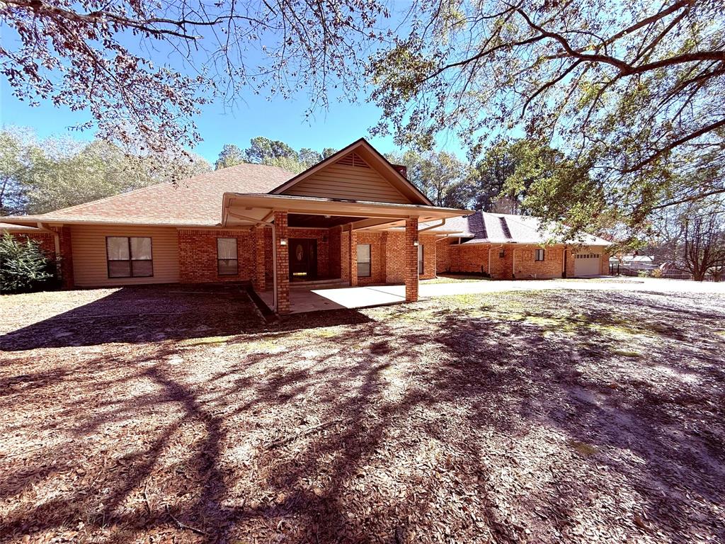 12098 Squirrel Road Pittsburg, TX 75686 - Photo 3 of 37 front view of a house with a yard