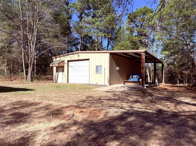 a view of a house with a yard and garage