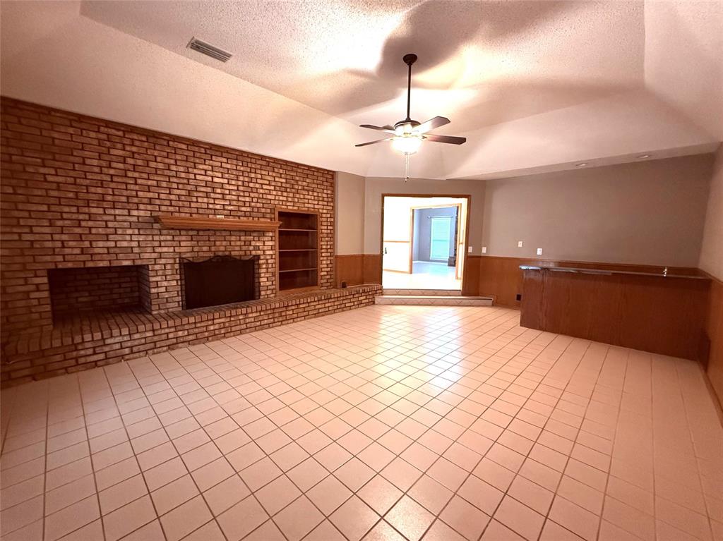 12098 Squirrel Road Pittsburg, TX 75686 - Photo 6 of 37 an empty room with windows and fireplace