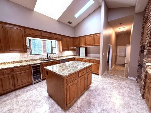 a kitchen with a stove a refrigerator and a oven