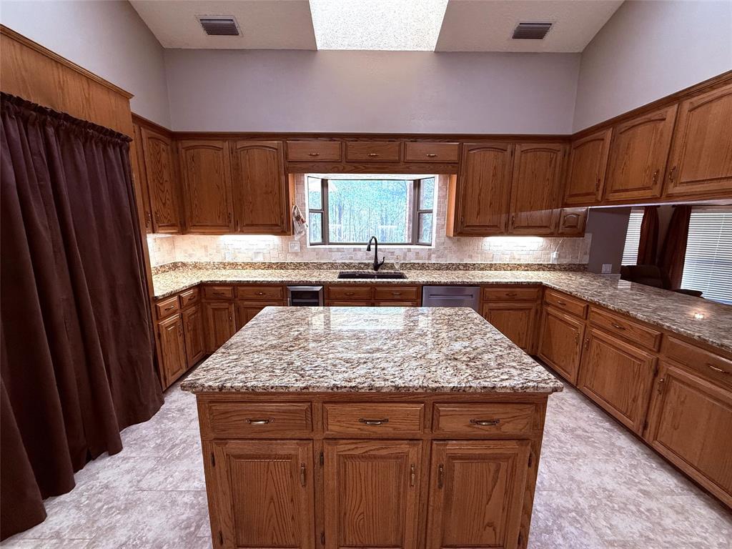 12098 Squirrel Road Pittsburg, TX 75686 - Photo 10 of 37 a kitchen with a sink stove and refrigerator