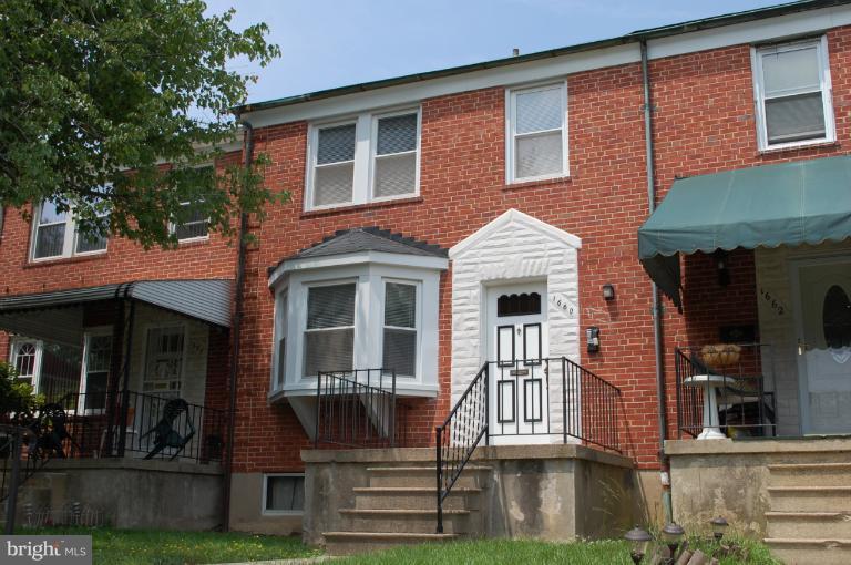 1660 Northbourne Road Baltimore, MD 21239 - Photo 1 of 11 a front view of a house with garden