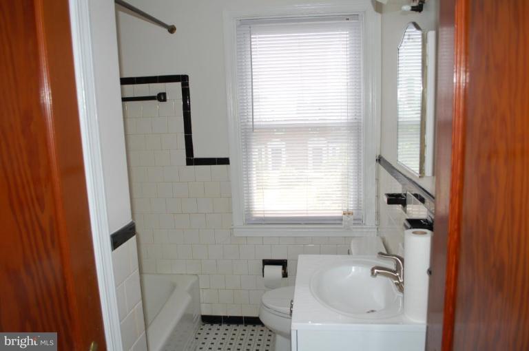 1660 Northbourne Road Baltimore, MD 21239 - Photo 7 of 11 a bathroom with a bathtub and window