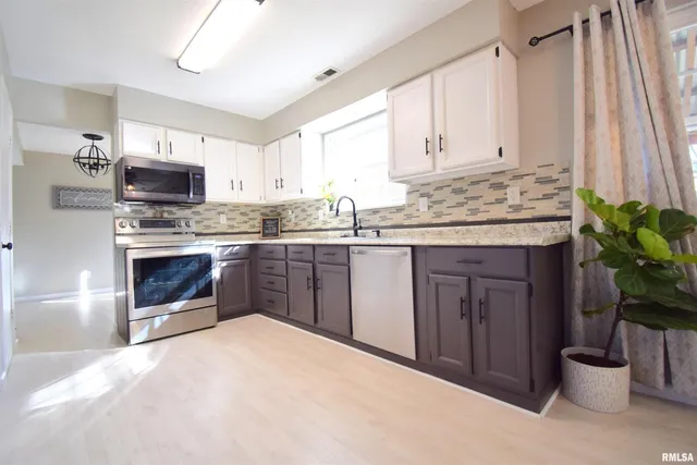 a kitchen with a sink and a stove top oven
