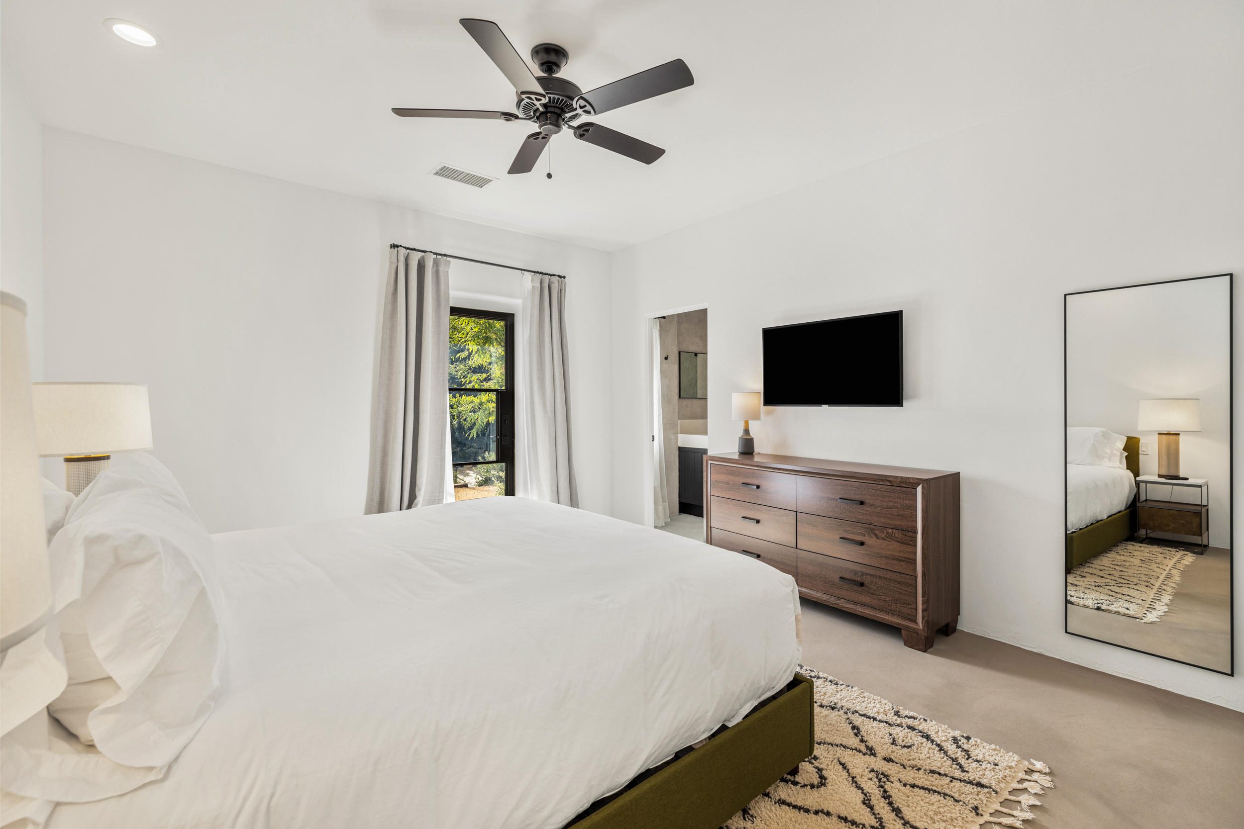 594 West Stevens Road, Unit A Palm Springs, CA 92262 - Photo 106 of 133 a bedroom with a bed and a flat screen tv