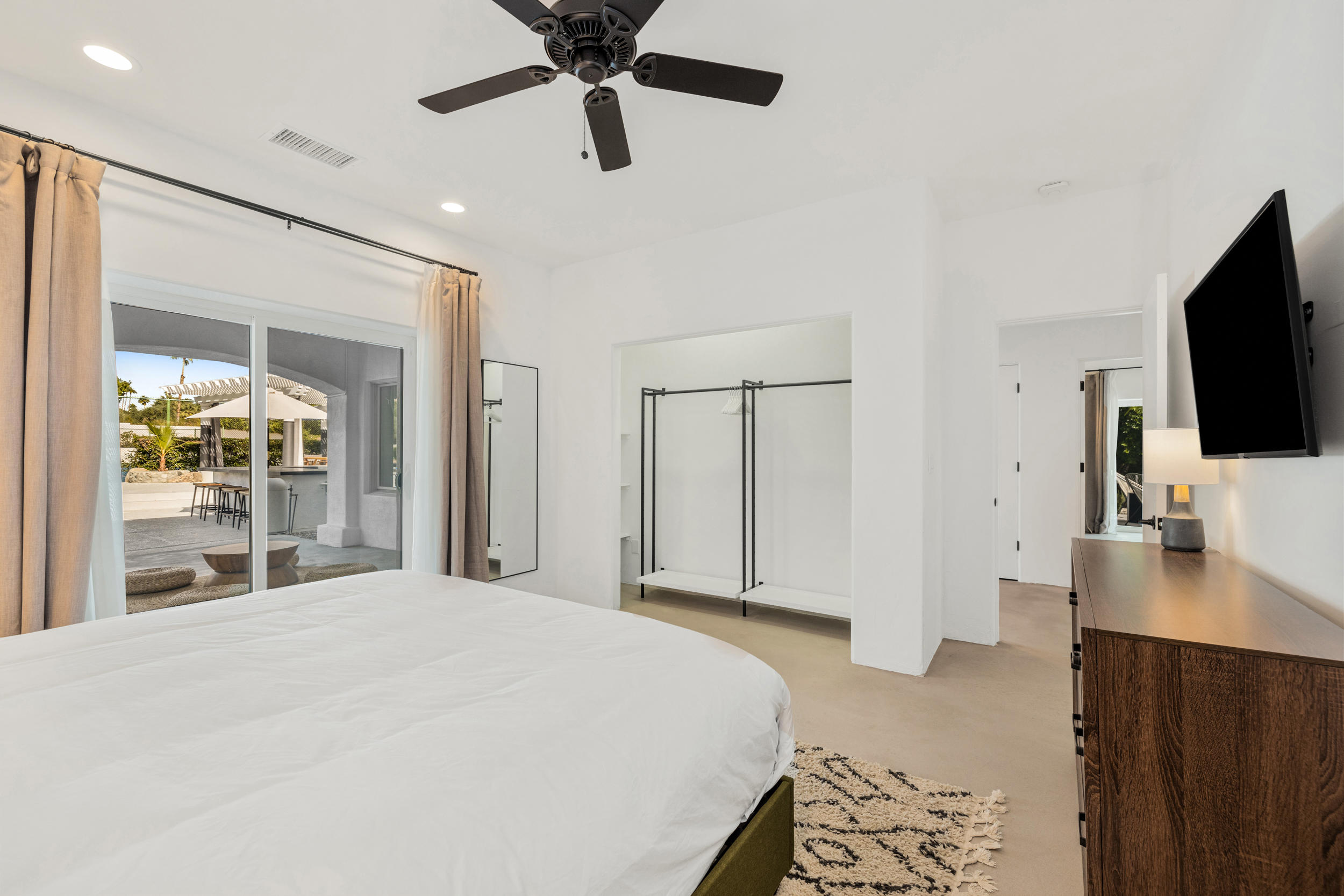 594 West Stevens Road, Unit A Palm Springs, CA 92262 - Photo 114 of 133 a bedroom with a bed window and a flat screen tv