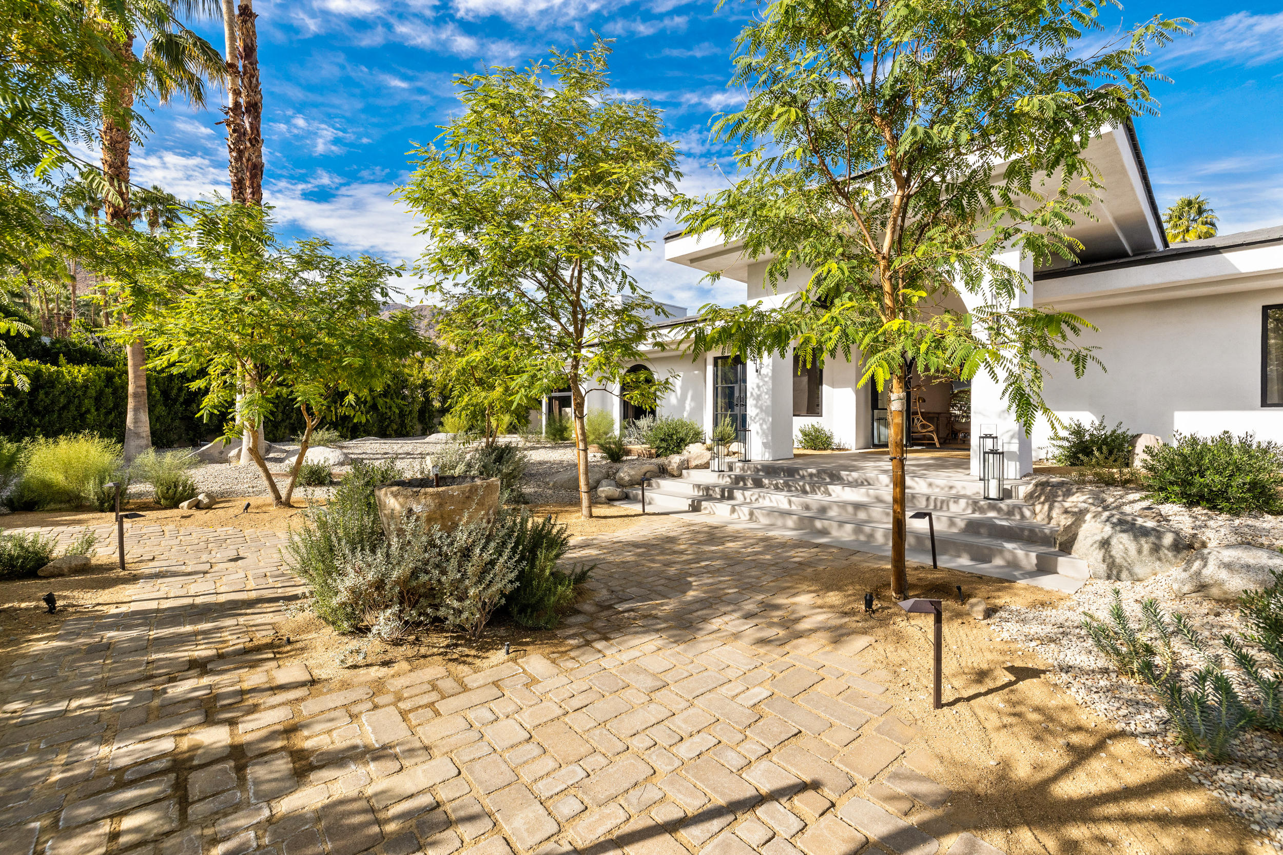 594 West Stevens Road, Unit A Palm Springs, CA 92262 - Photo 20 of 133 a view of a yard with plants and large trees