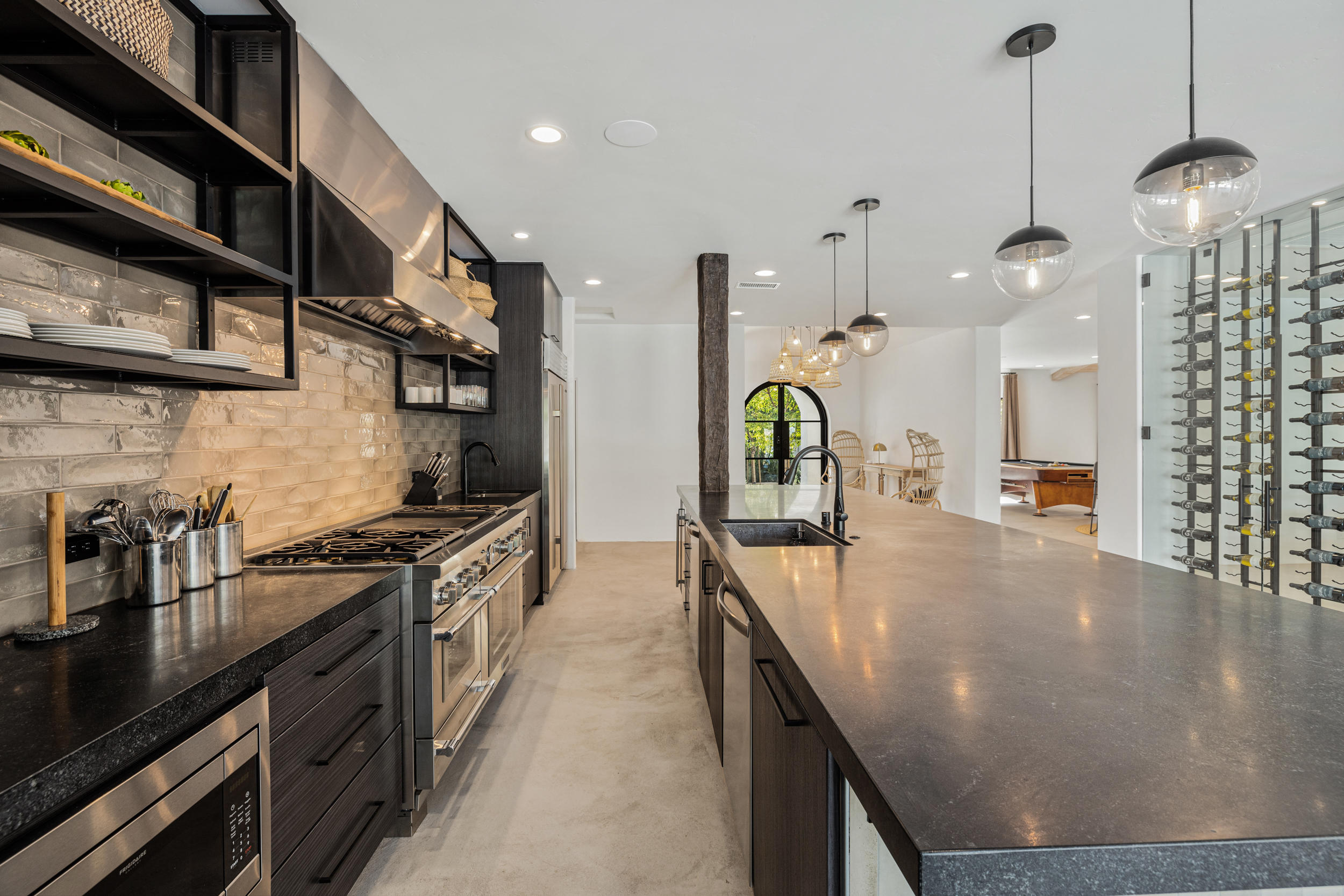 594 West Stevens Road, Unit A Palm Springs, CA 92262 - Photo 34 of 133 a kitchen with stainless steel appliances granite countertop a sink a stove and a wooden floors