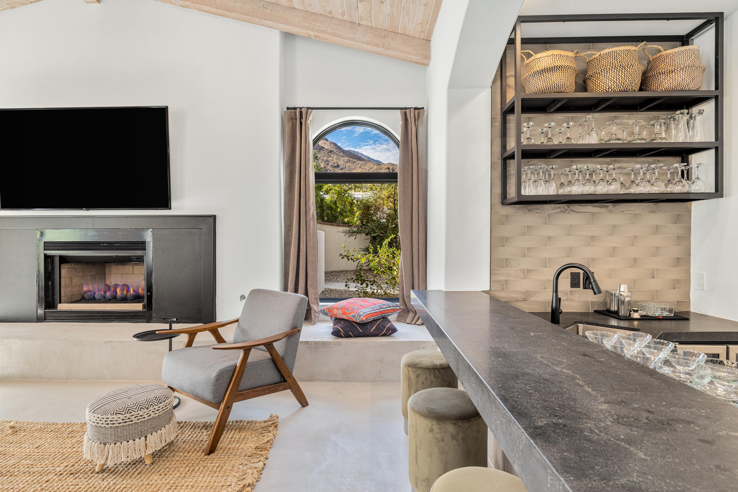 594 West Stevens Road, Unit A Palm Springs, CA 92262 - Photo 43 of 133 a living room with furniture a flat screen tv and a fireplace