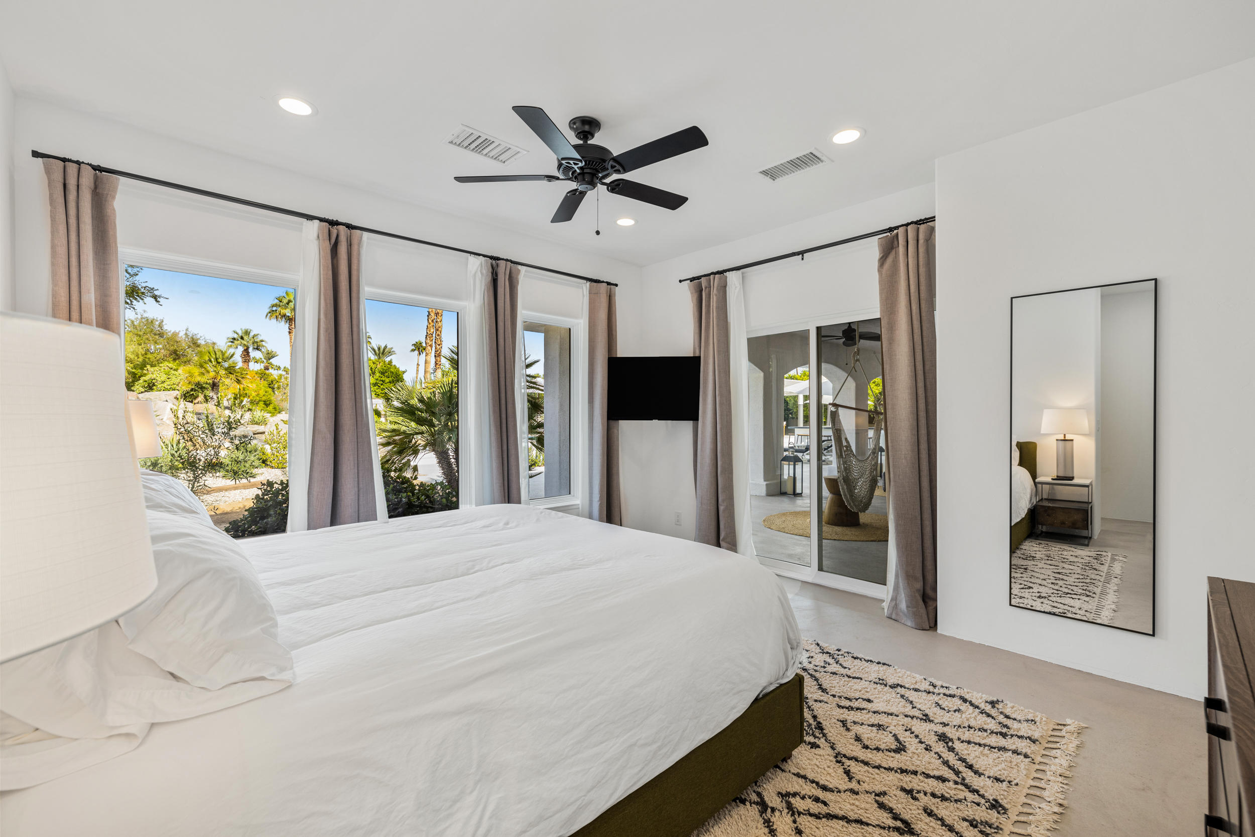 594 West Stevens Road, Unit A Palm Springs, CA 92262 - Photo 47 of 133 a bedroom with a bed and a large mirror