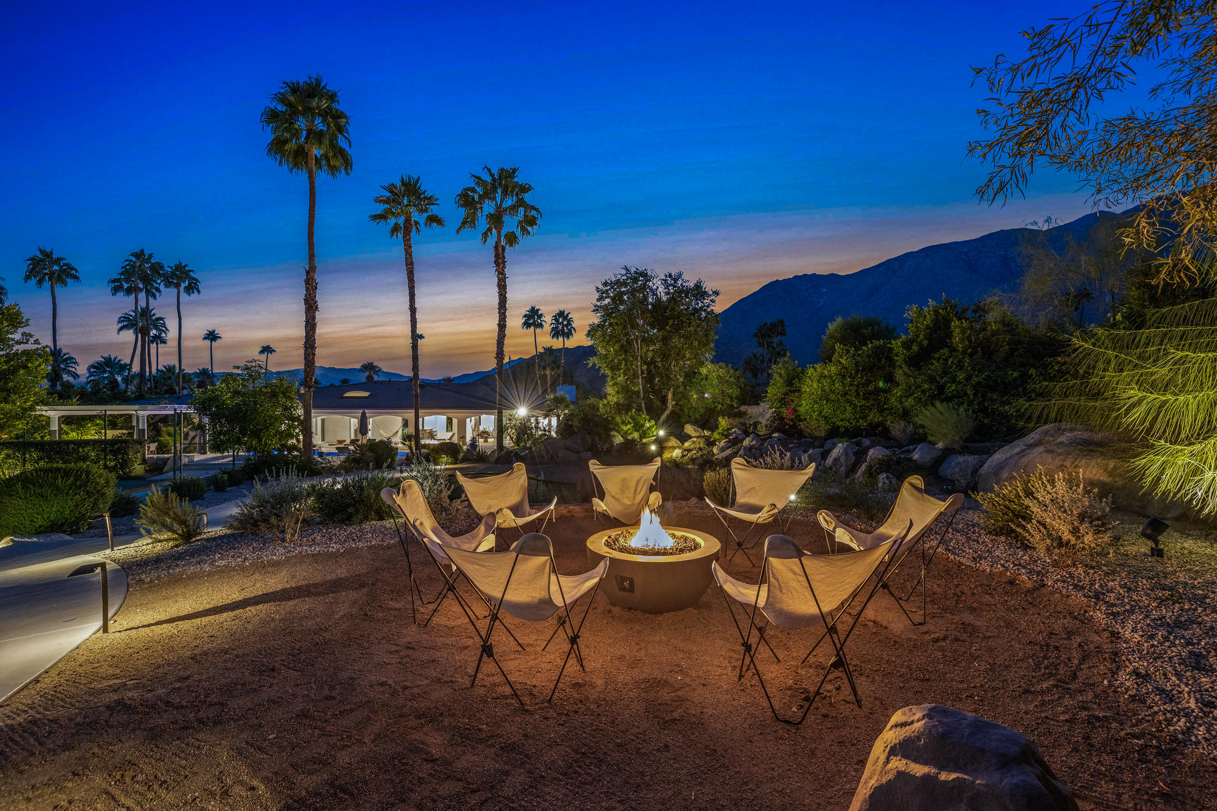 594 West Stevens Road, Unit A Palm Springs, CA 92262 - Photo 77 of 133 a view of a chairs and table in patio with a fire pit