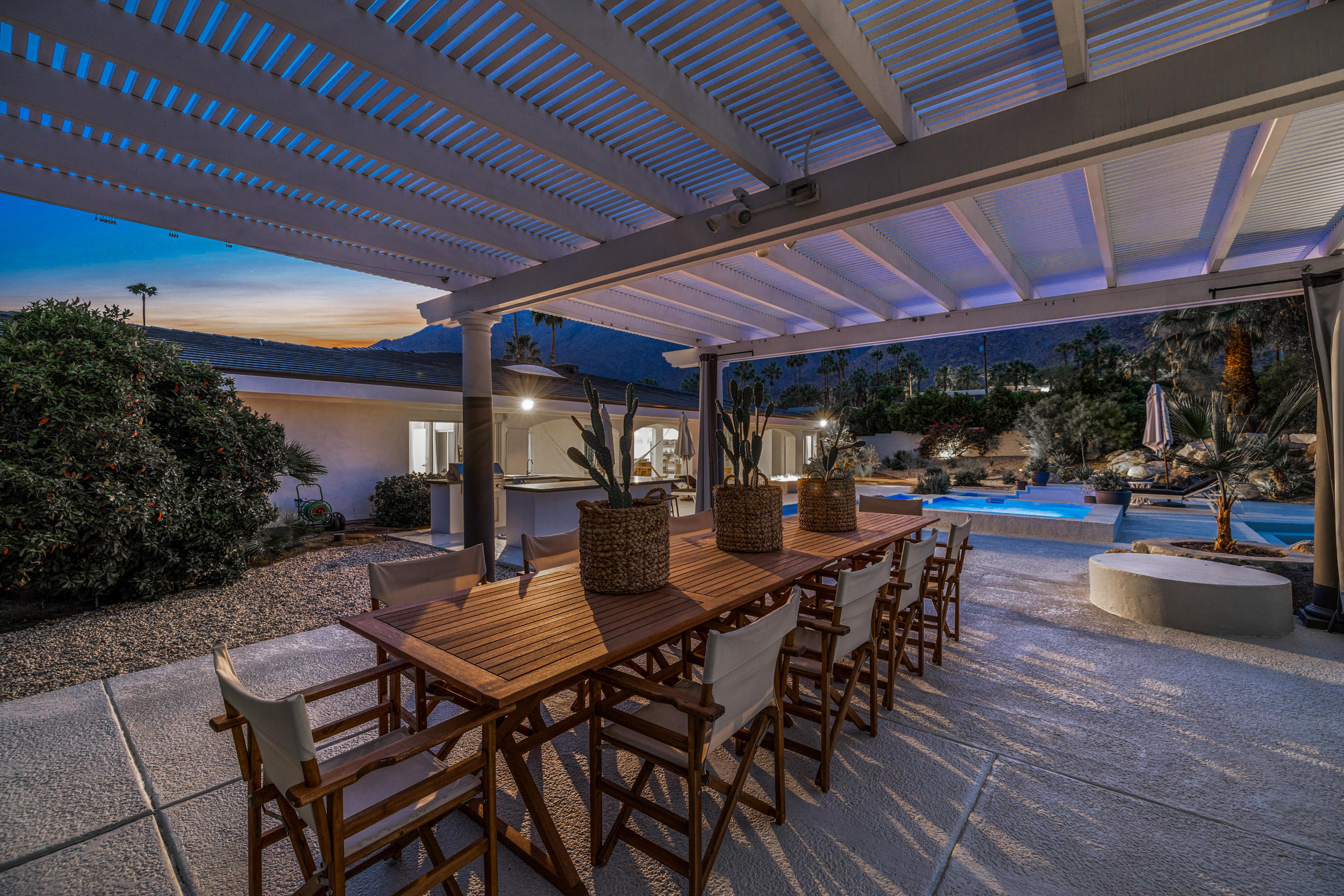 594 West Stevens Road, Unit A Palm Springs, CA 92262 - Photo 88 of 133 a view of a patio with table and chairs potted plants with wooden floor