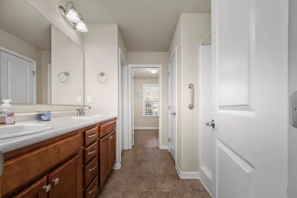 a bathroom with a sink a vanity a mirror and a shower