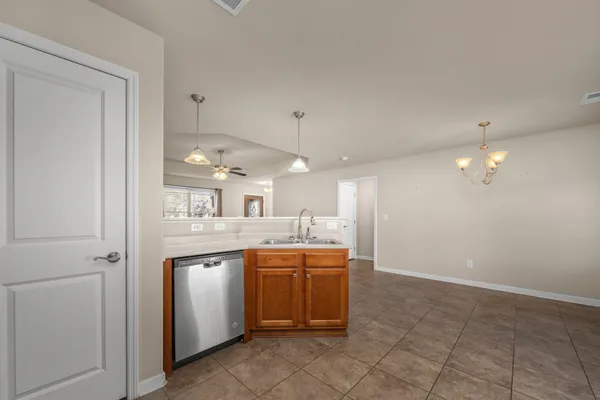 a kitchen with granite countertop a sink and steel appliances