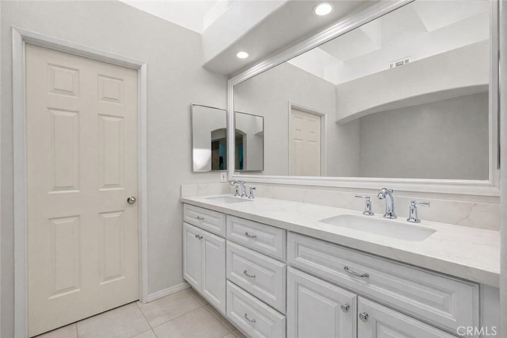 9 Diamant Way Aliso Viejo, CA 92656 - Photo 18 of 33 a bathroom with double sink and a mirror
