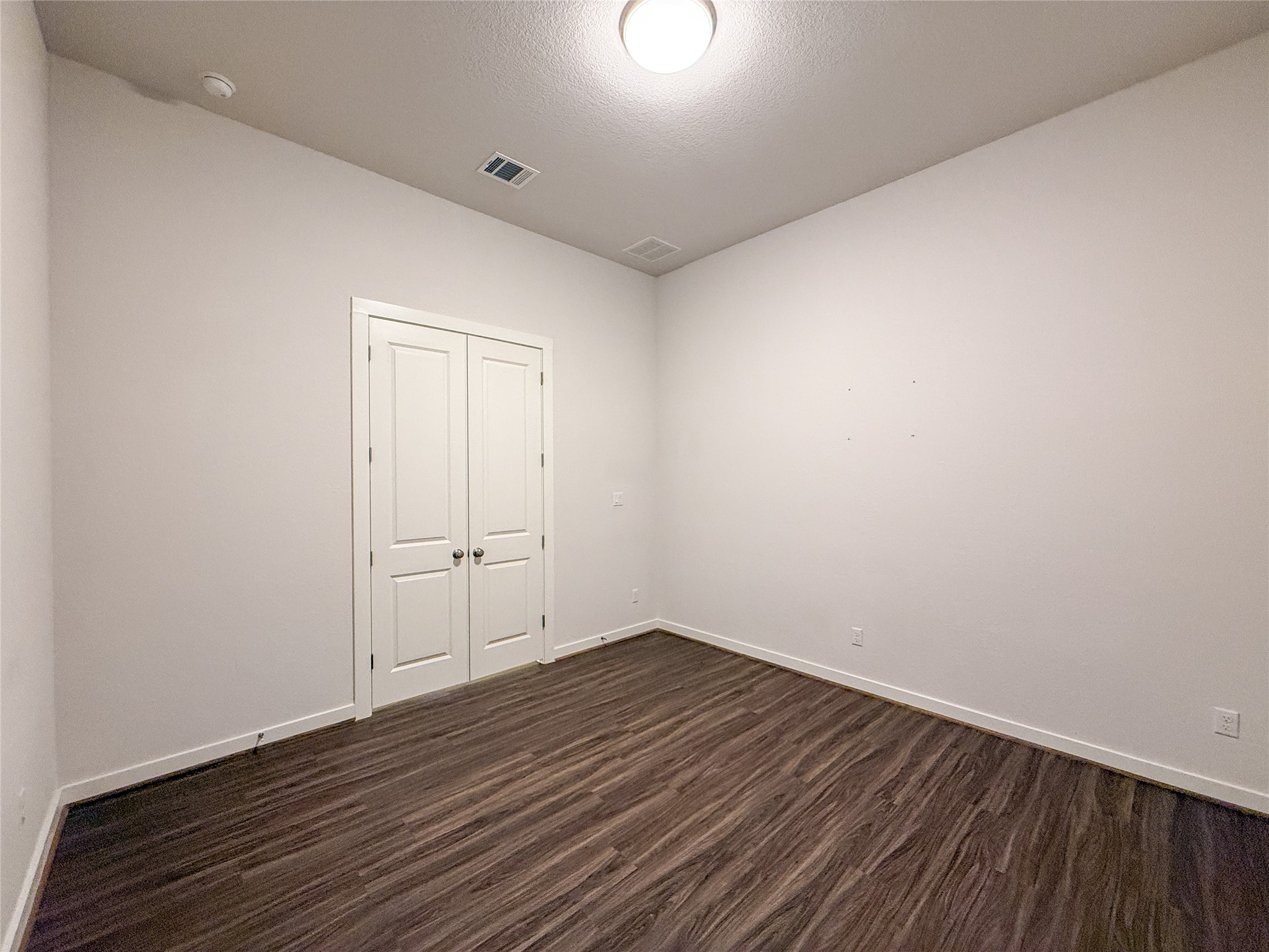 249 Heartleaf Road San Marcos, TX 78666 - Photo 29 of 38 Rich wood flooring adds warmth to this versatile room, ready for your personal touch.