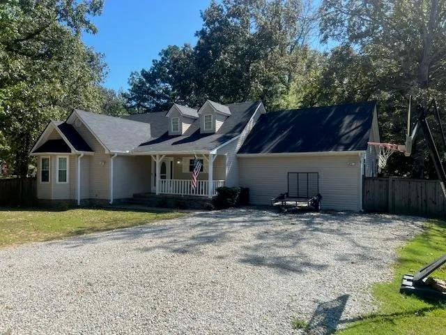 a house that has a tree in front of it