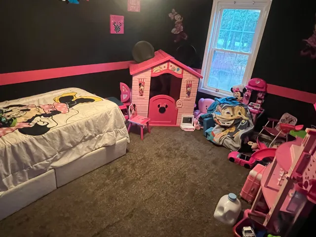 a bedroom with a bed and a couch