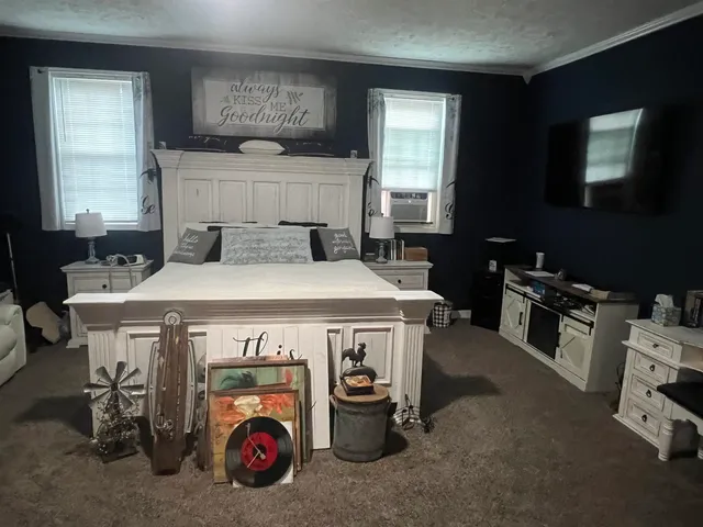 a utility room with furniture a flat screen tv and a window