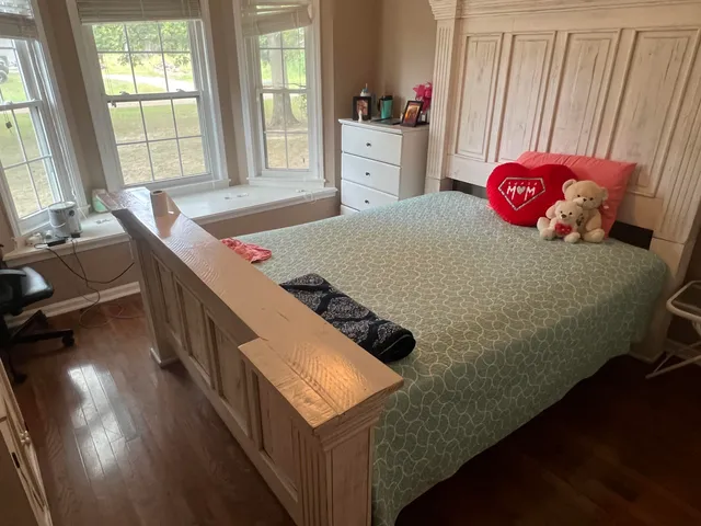 a bedroom with furniture and a window