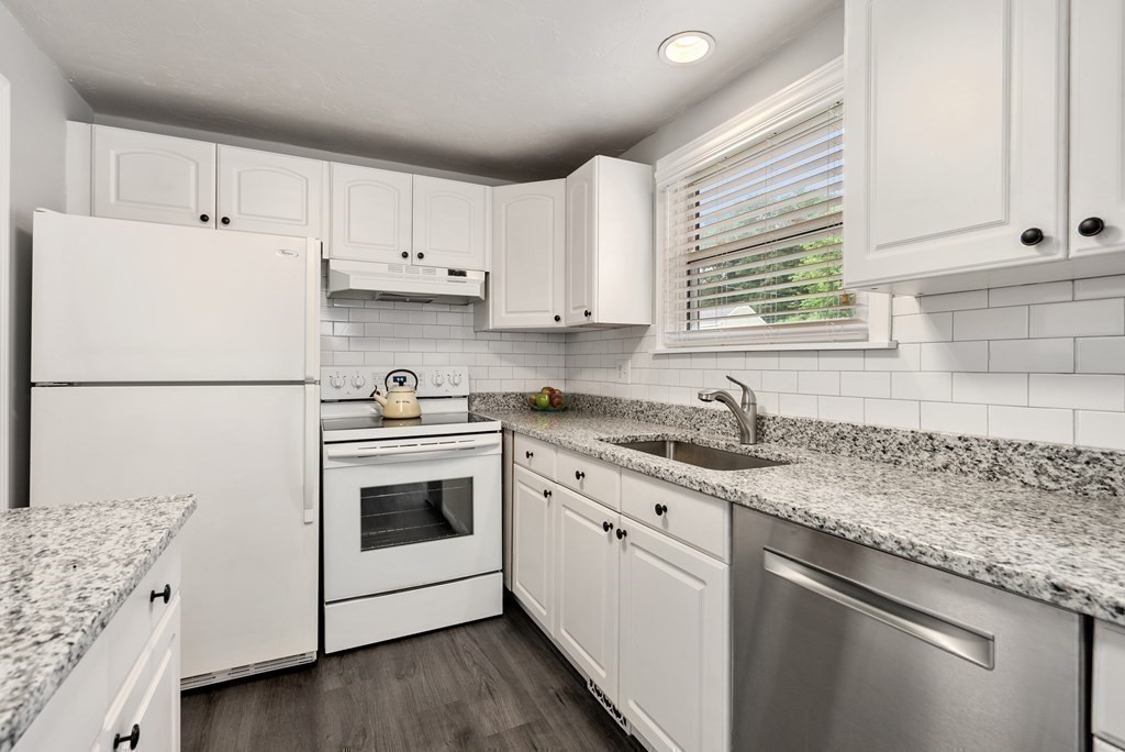 12 Cypress Road Natick, MA 01760 - Photo 11 of 41 a kitchen with granite countertop white cabinets and white appliances