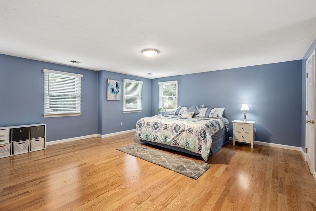 12 Cypress Road Natick, MA 01760 - Photo 18 of 41 a bedroom with a large bed wooden floor and window