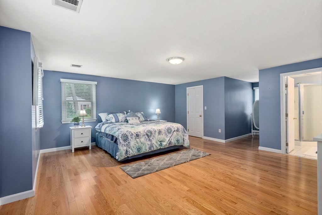 12 Cypress Road Natick, MA 01760 - Photo 20 of 41 a bedroom with a large bed lamps and wooden floor