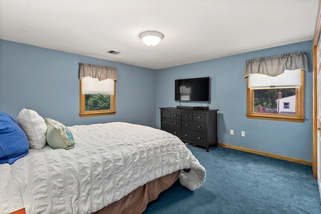 12 Cypress Road Natick, MA 01760 - Photo 25 of 41 a bedroom with a bed and a flat screen tv