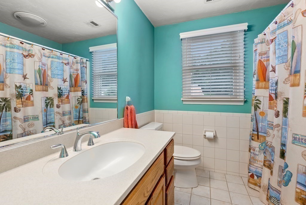 12 Cypress Road Natick, MA 01760 - Photo 26 of 41 a bathroom with a sink a toilet and shower curtain