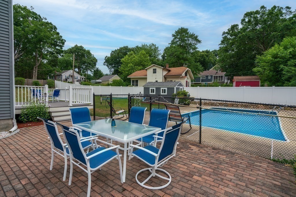 12 Cypress Road Natick, MA 01760 - Photo 30 of 41 a swimming pool with outdoor seating and yard in the back