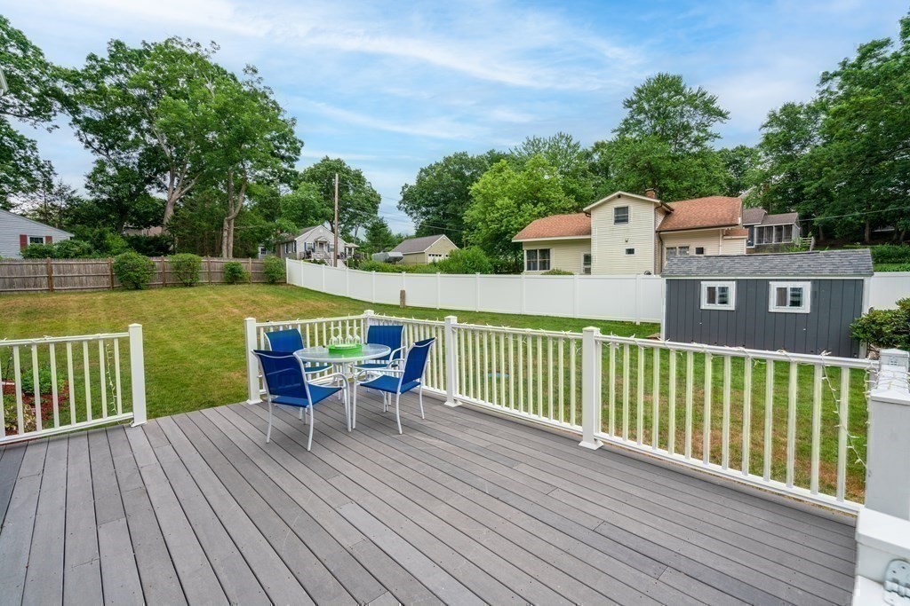12 Cypress Road Natick, MA 01760 - Photo 31 of 41 a view of a deck with table and chairs and wooden floor