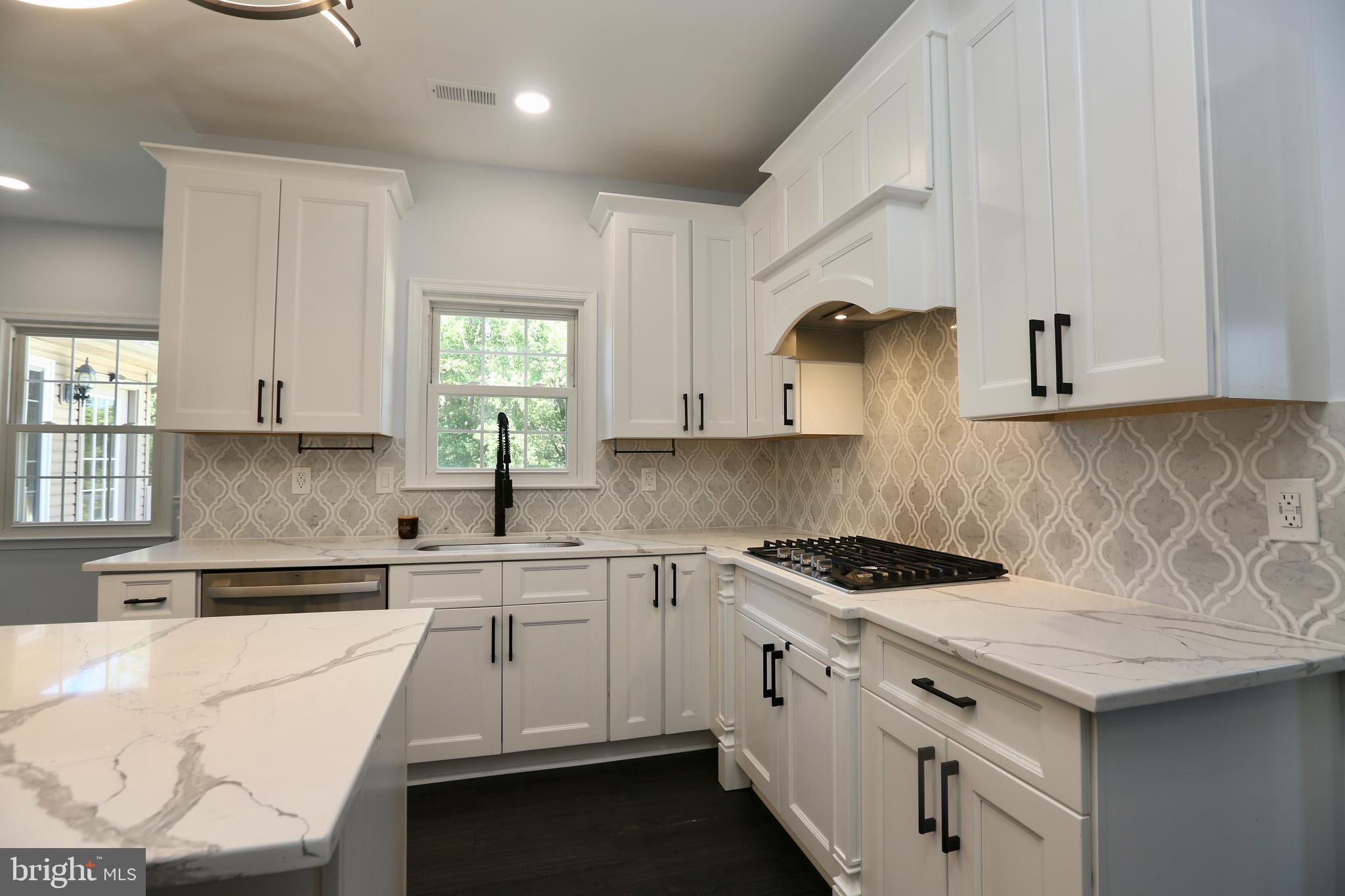 16 Cotswold Way Sewell, NJ 08080 - Photo 11 of 52 a kitchen with white cabinets and white appliances
