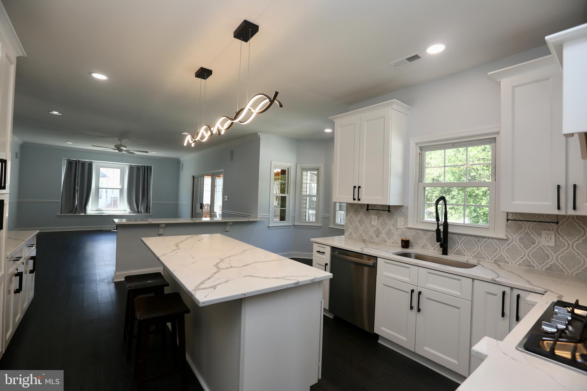 16 Cotswold Way Sewell, NJ 08080 - Photo 12 of 52 a kitchen with a sink and chandelier
