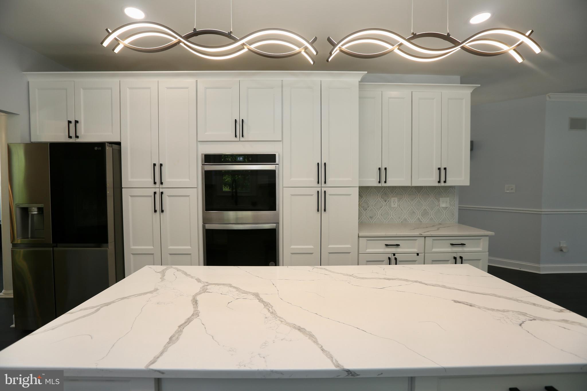 16 Cotswold Way Sewell, NJ 08080 - Photo 13 of 52 a kitchen with a refrigerator and cabinets