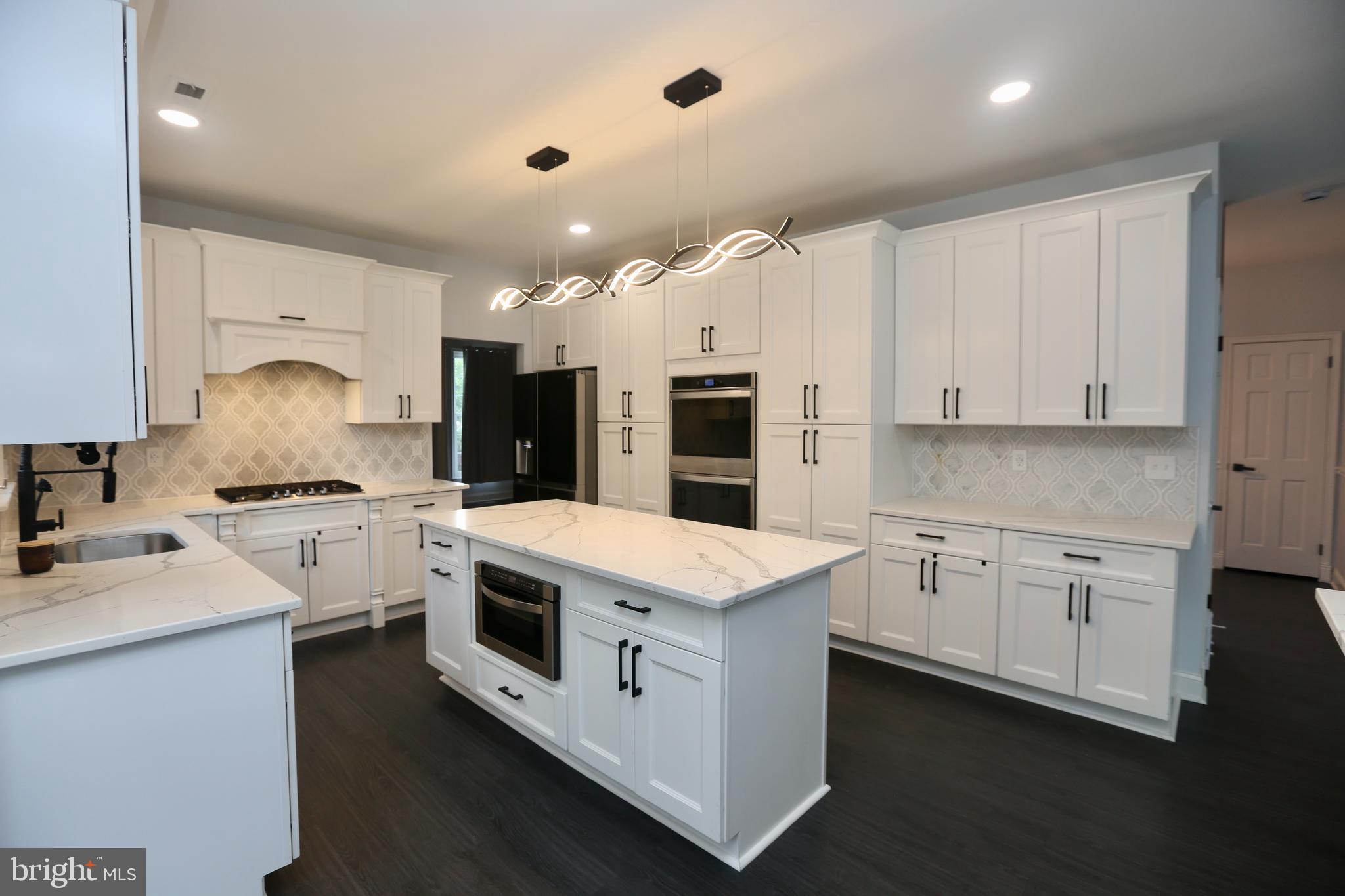 16 Cotswold Way Sewell, NJ 08080 - Photo 15 of 52 a kitchen with white cabinets and white appliances