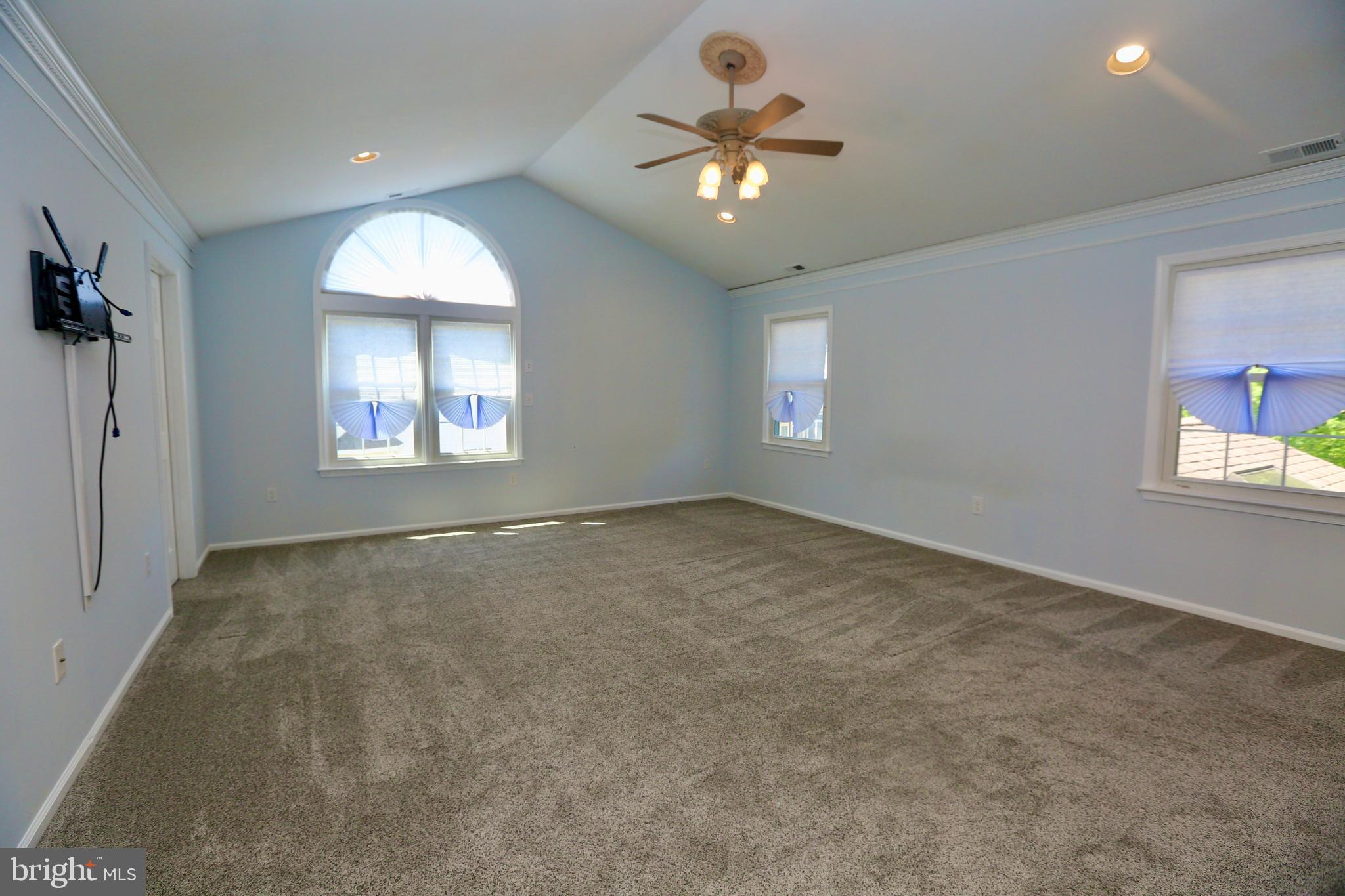 16 Cotswold Way Sewell, NJ 08080 - Photo 26 of 52 an empty room with a chandelier fan and windows