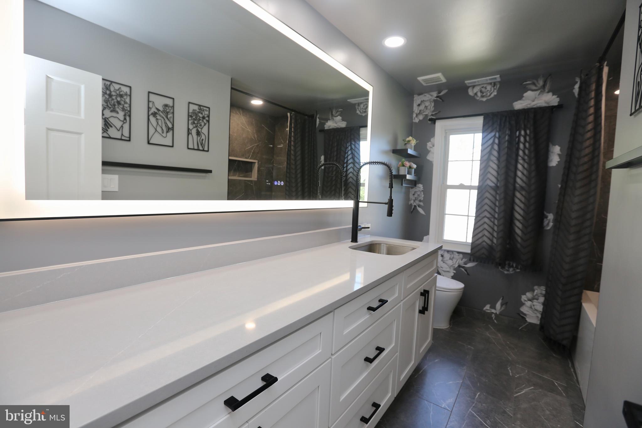 16 Cotswold Way Sewell, NJ 08080 - Photo 41 of 52 a spacious bathroom with a double vanity sink and a mirror
