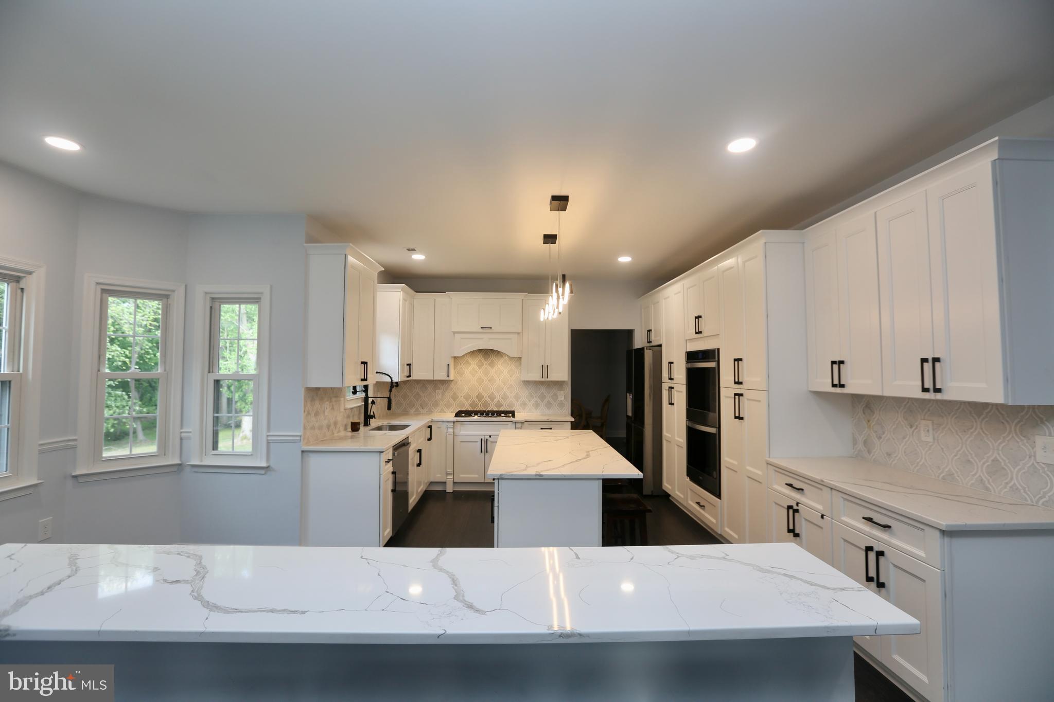 16 Cotswold Way Sewell, NJ 08080 - Photo 10 of 52 a large kitchen with stainless steel appliances a large counter top a sink a refrigerator and a window