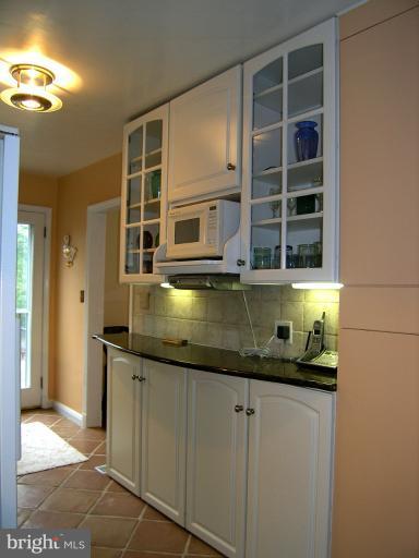 190 Stanmore Road Baltimore, MD 21212 - Photo 4 of 15 a bathroom with a granite countertop sink and a mirror