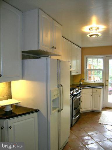 190 Stanmore Road Baltimore, MD 21212 - Photo 5 of 15 a kitchen with stainless steel appliances granite countertop a sink stove and refrigerator
