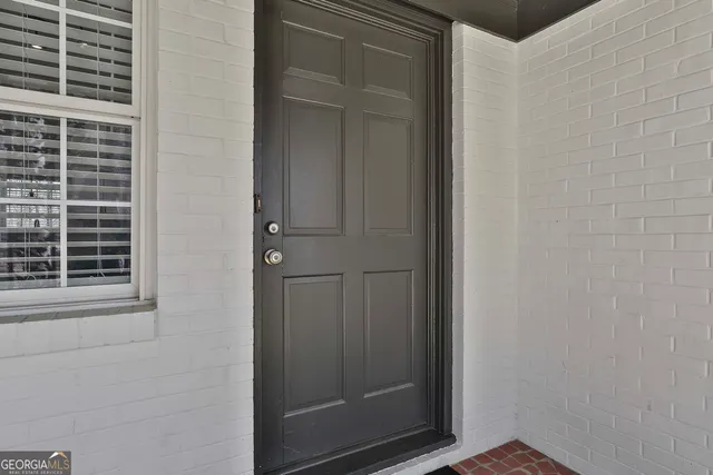 a view of kitchen with refrigerator and wooden floor